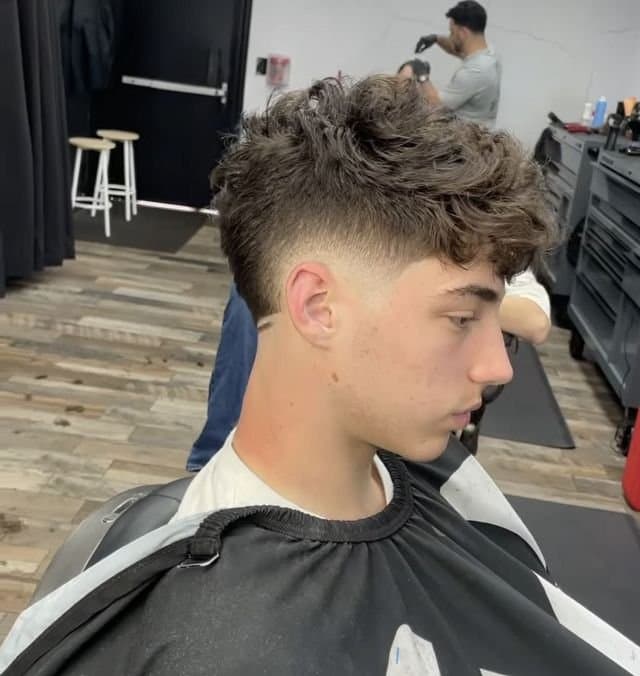 Textured curly crop with a clean low drop fade, cut by Giancarlo Colombo